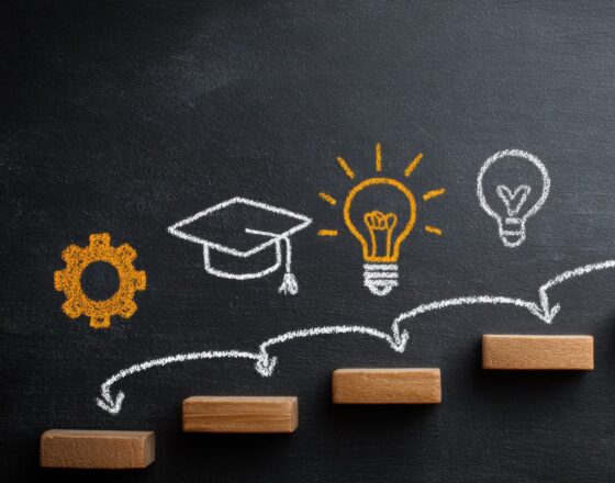 A chalk illustration of steps leading to a graduation cap.