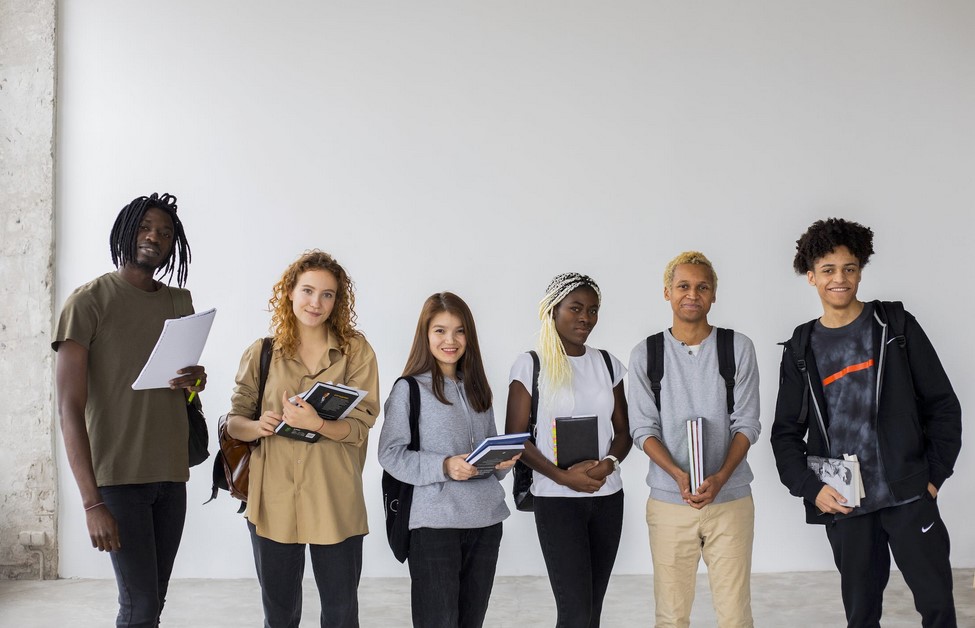 Group of multiethnic students with books and documents