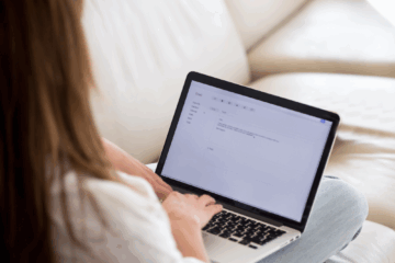 Women sitting on a couch and working on their computer