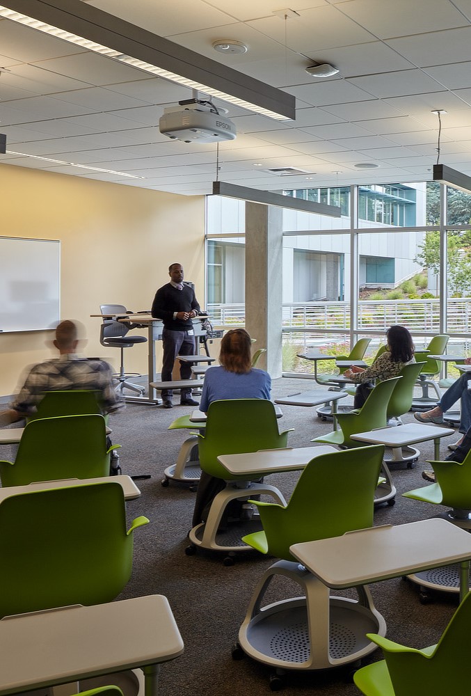 A classroom being taught by a teacher while students listen