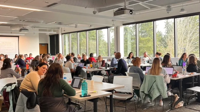 A classroom full of people talking and networking with one another
