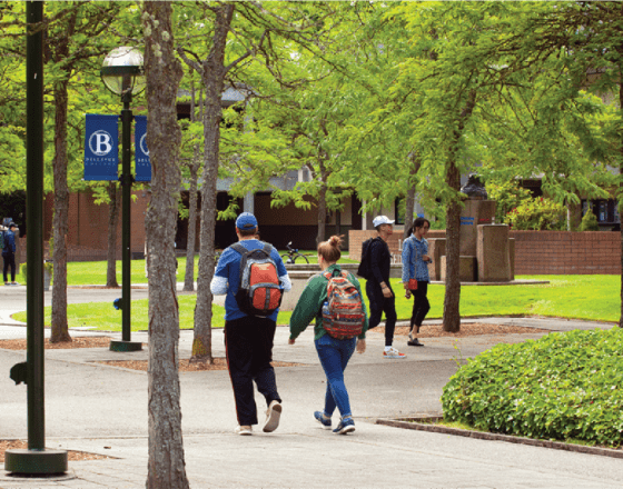 A photo of Bellevue college's campus with students roaming and walking around
