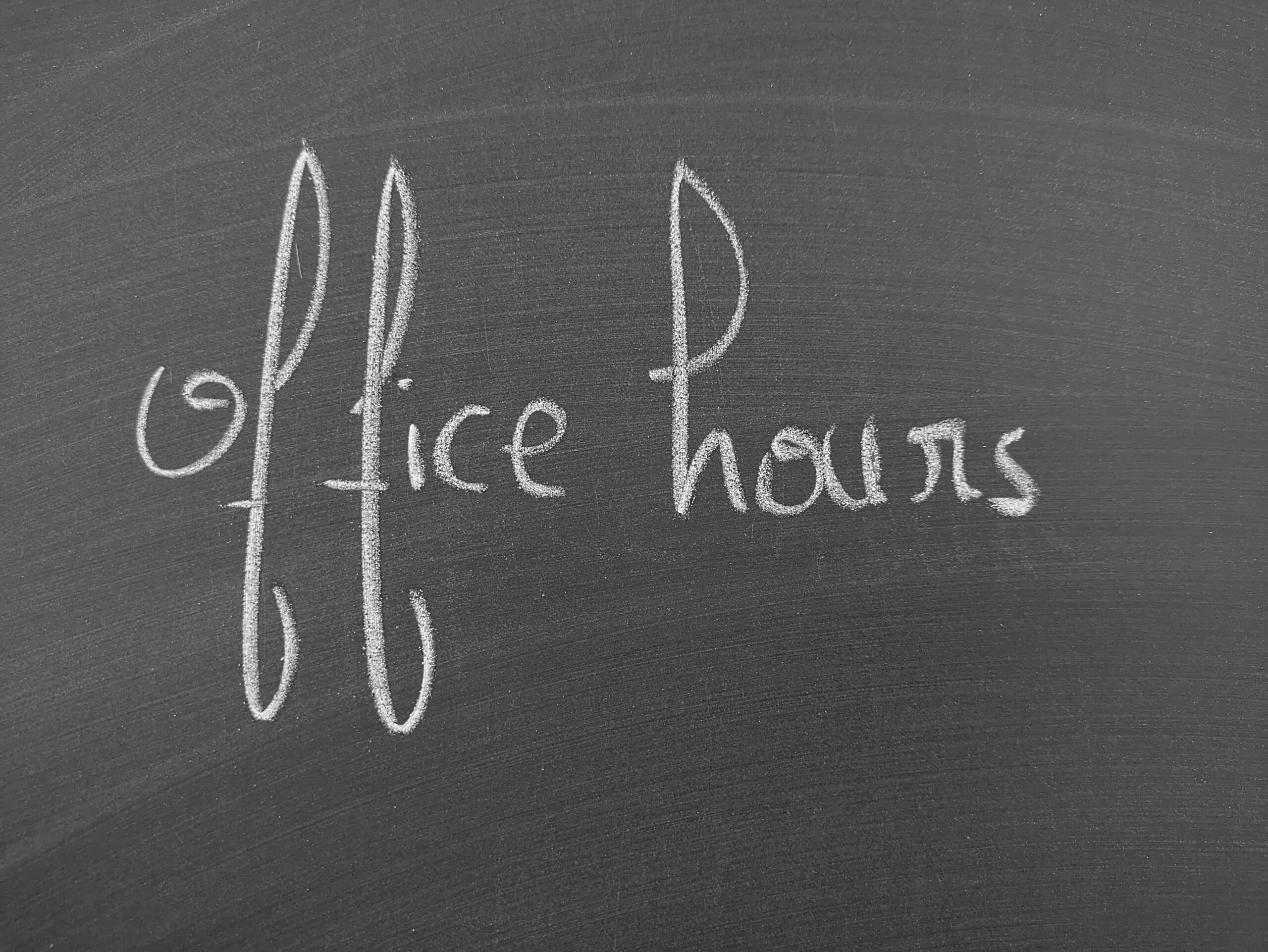 The words "Office Hours" written on a blackboard in chalk
