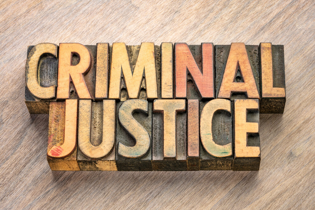 The words "Criminal Justice" in wood blocks.