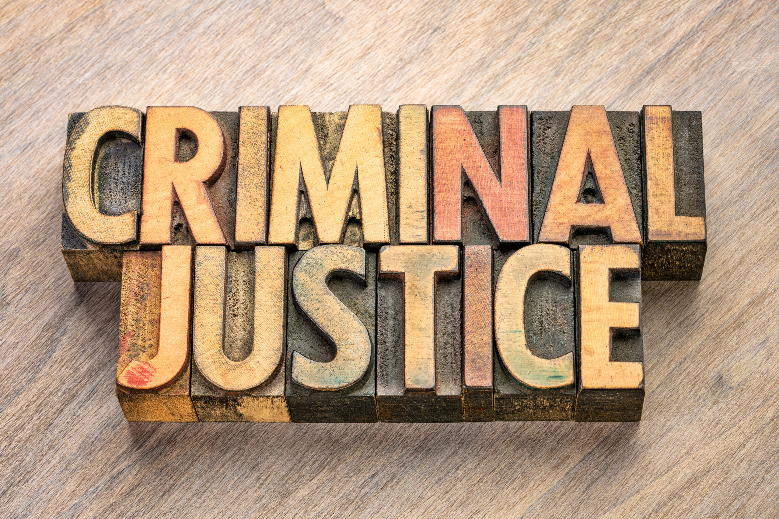 The words "Criminal Justice" in wood blocks