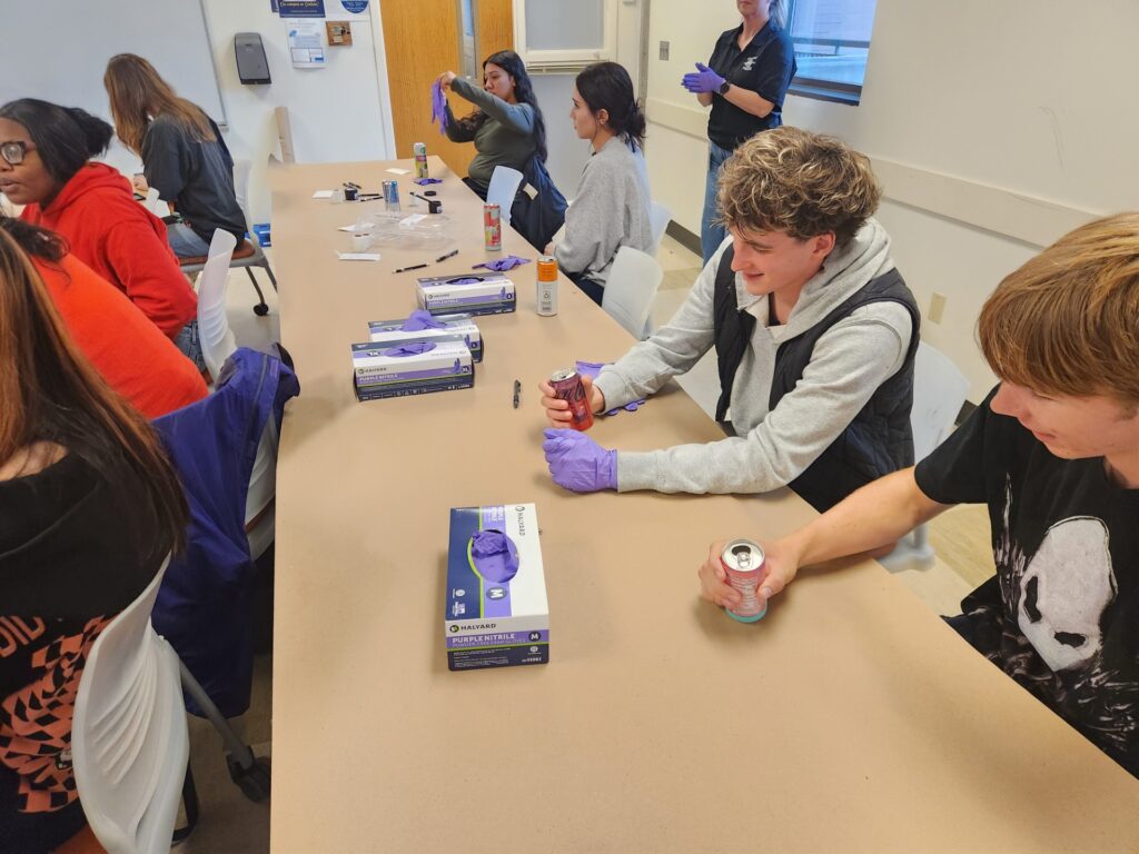 Students engaging in fingerprinting activity with the Seattle Police Department