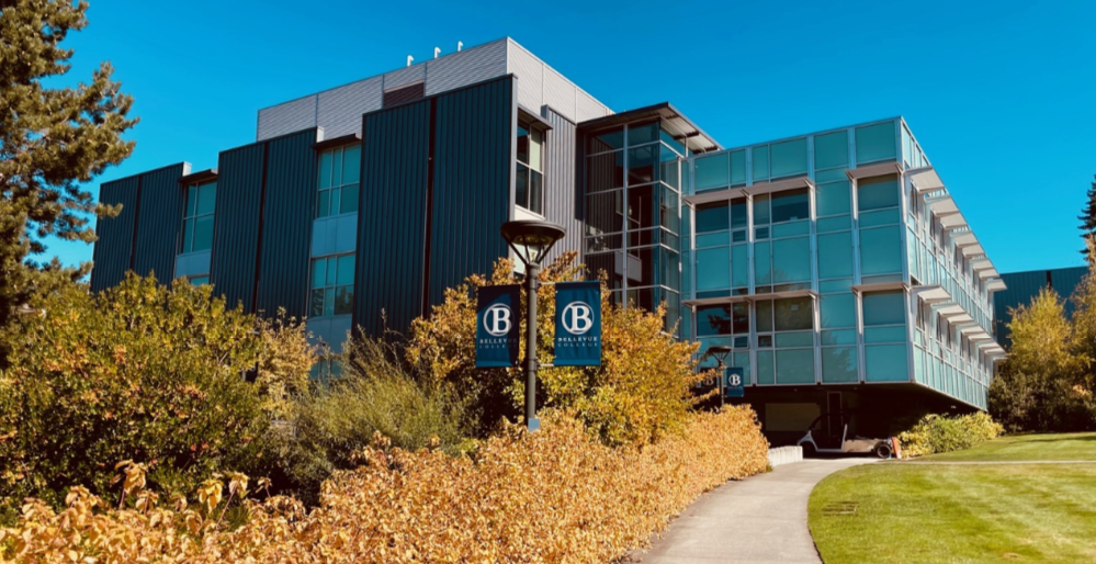 Image of Bellevue College building with golden autumn foliage in foreground