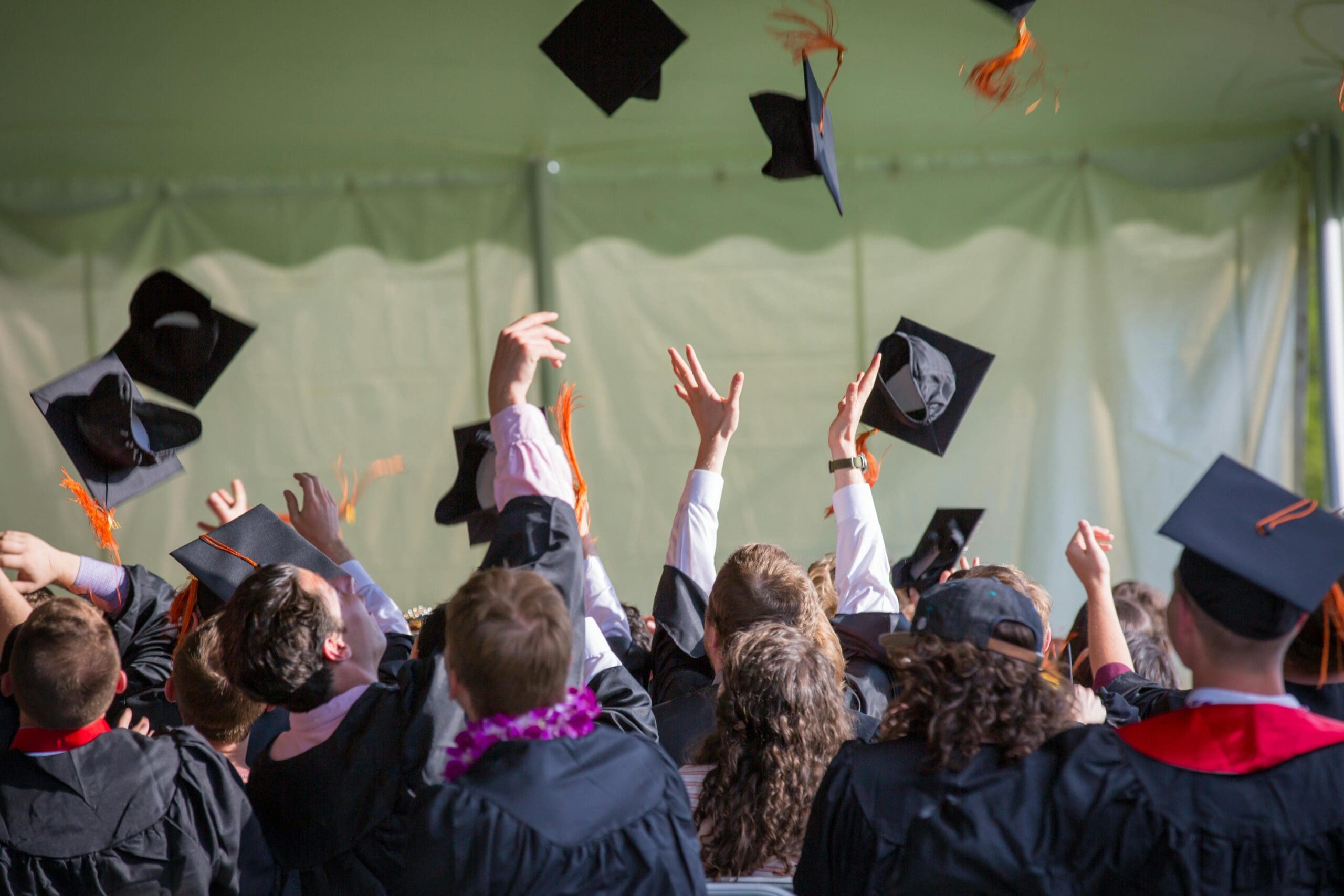 graduates throwing their caps in the air