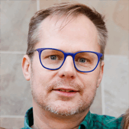 headshot of George Rowe wearing glasses and smiling
