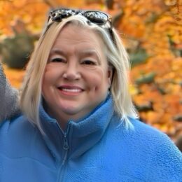 Jackie Hubbard outside on a fall day smiling