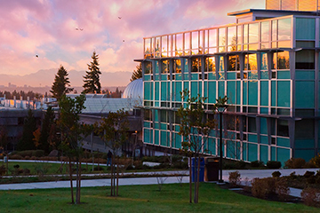 Bellevue College's S Building glows in the light near dusk.