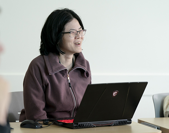 A student smiles while listening in class.