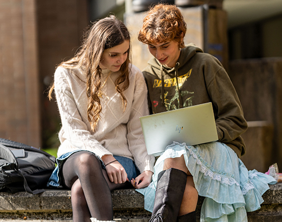 Two students share a laptop on the Bellevue College campus.