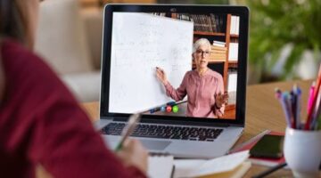 Student on laptop watching an online class