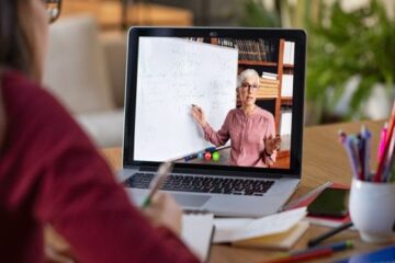 Student on laptop watching an online class