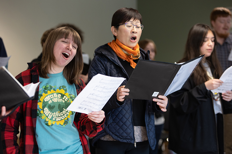 Choral students sing together.