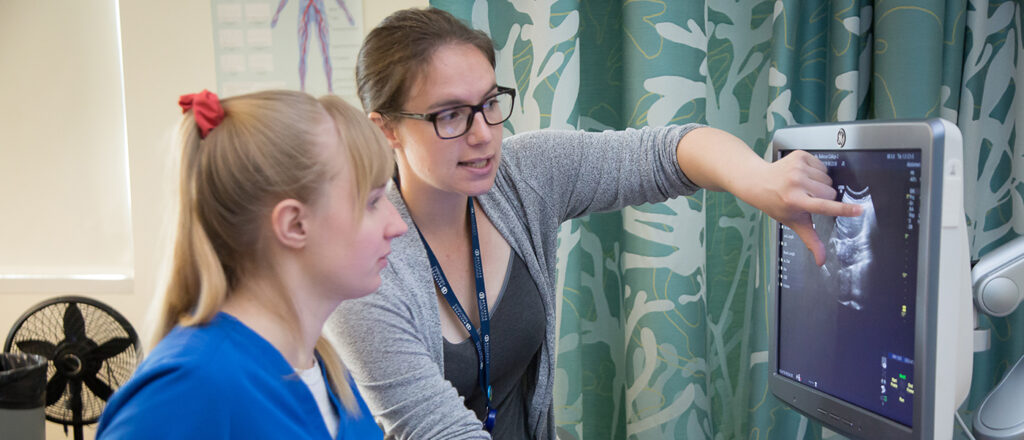 A student and teacher work one-on-one.