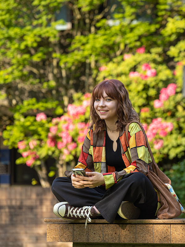 A student smiles on the Bellevue College campus.