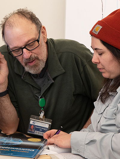 BC faculty assists a student.