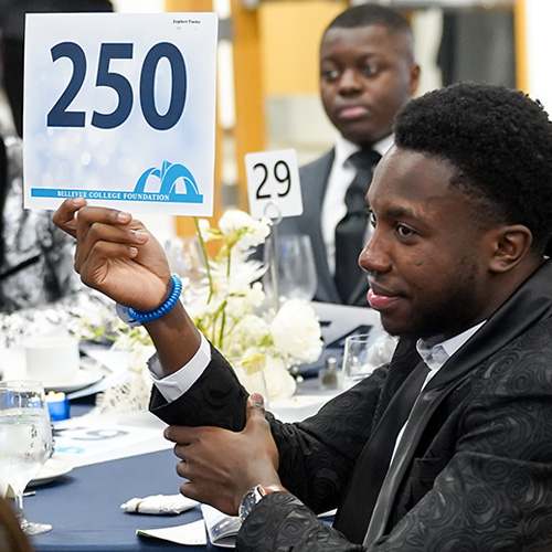 Guests raise signs to bid on auction items at the BC Foundation Gala.