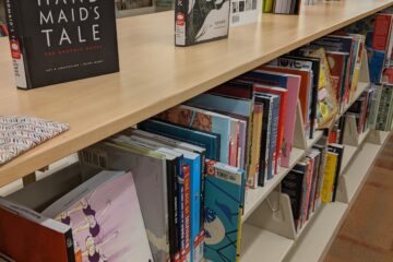 Graphic novels and comic books on library shelves