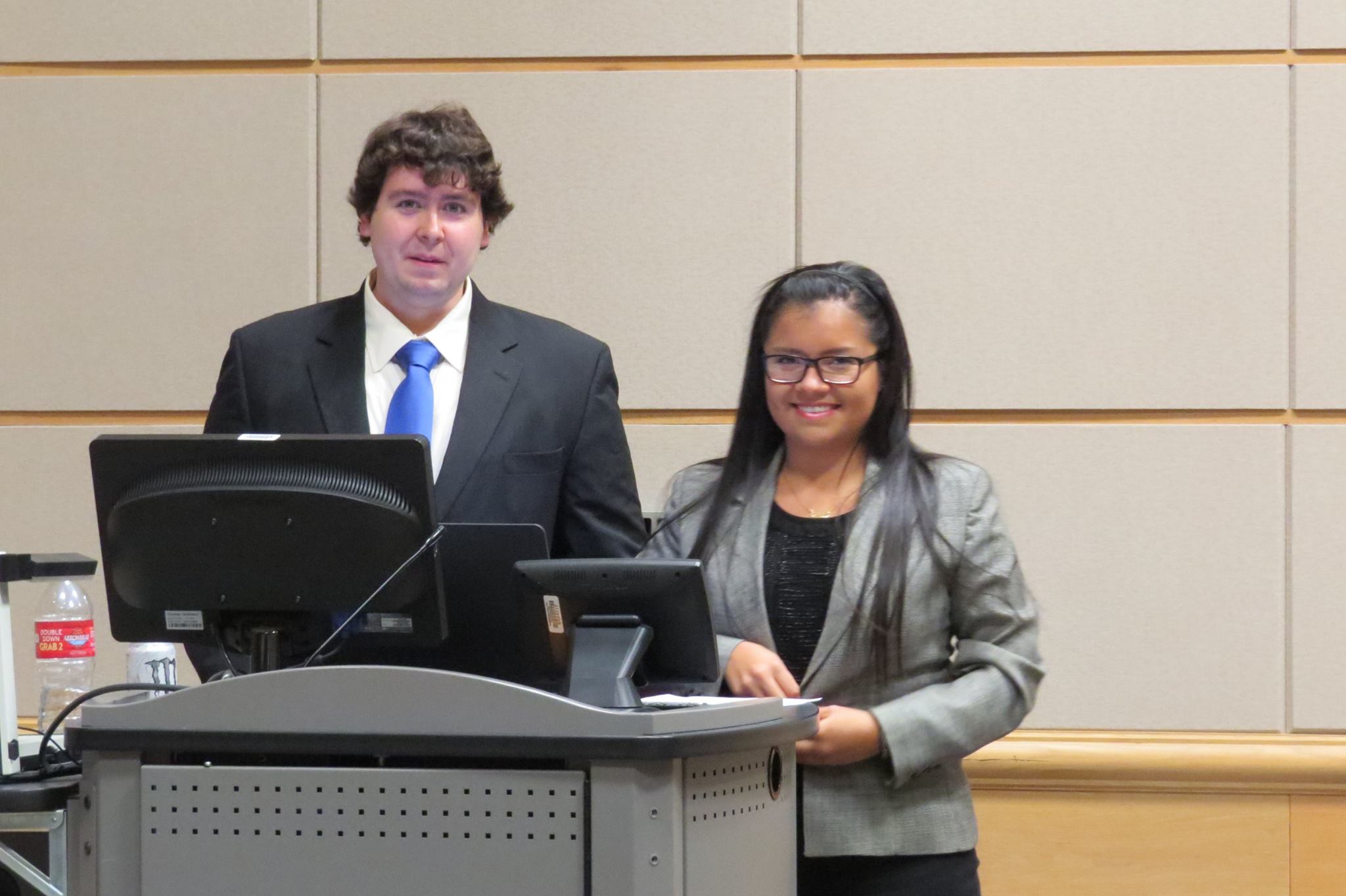 Two students standing at a podium