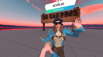 Avatar standing in a virtual desert environment labeled “XR Sandbox,” with a sign in the background and the avatar waving.