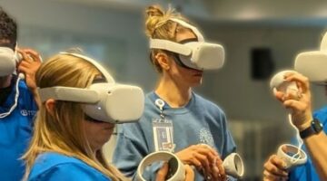 Group of people wearing VR headsets and holding controllers while interacting in an indoor setting