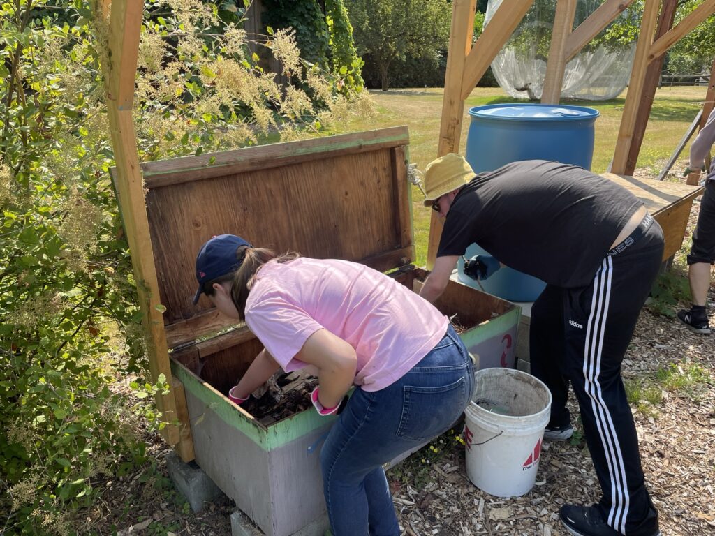 OLS students working in a worm bin