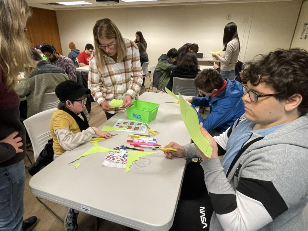 OLS students making party hats and games for their fall service learning project
