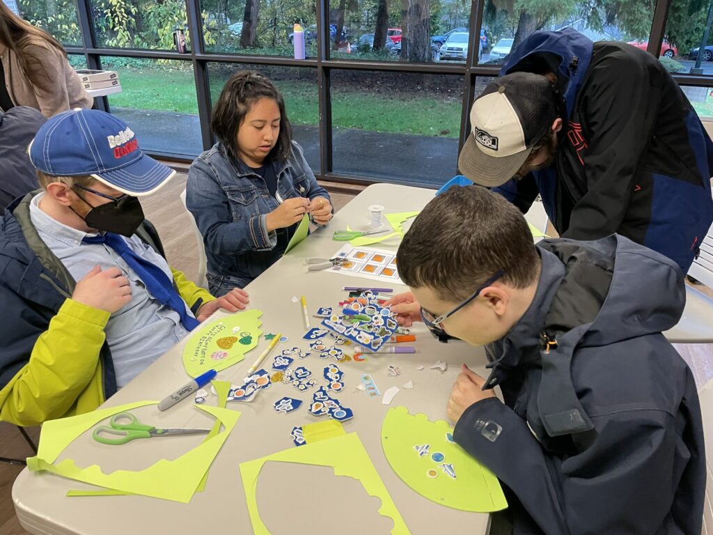 OLS students making party hats and games for their fall service learning project