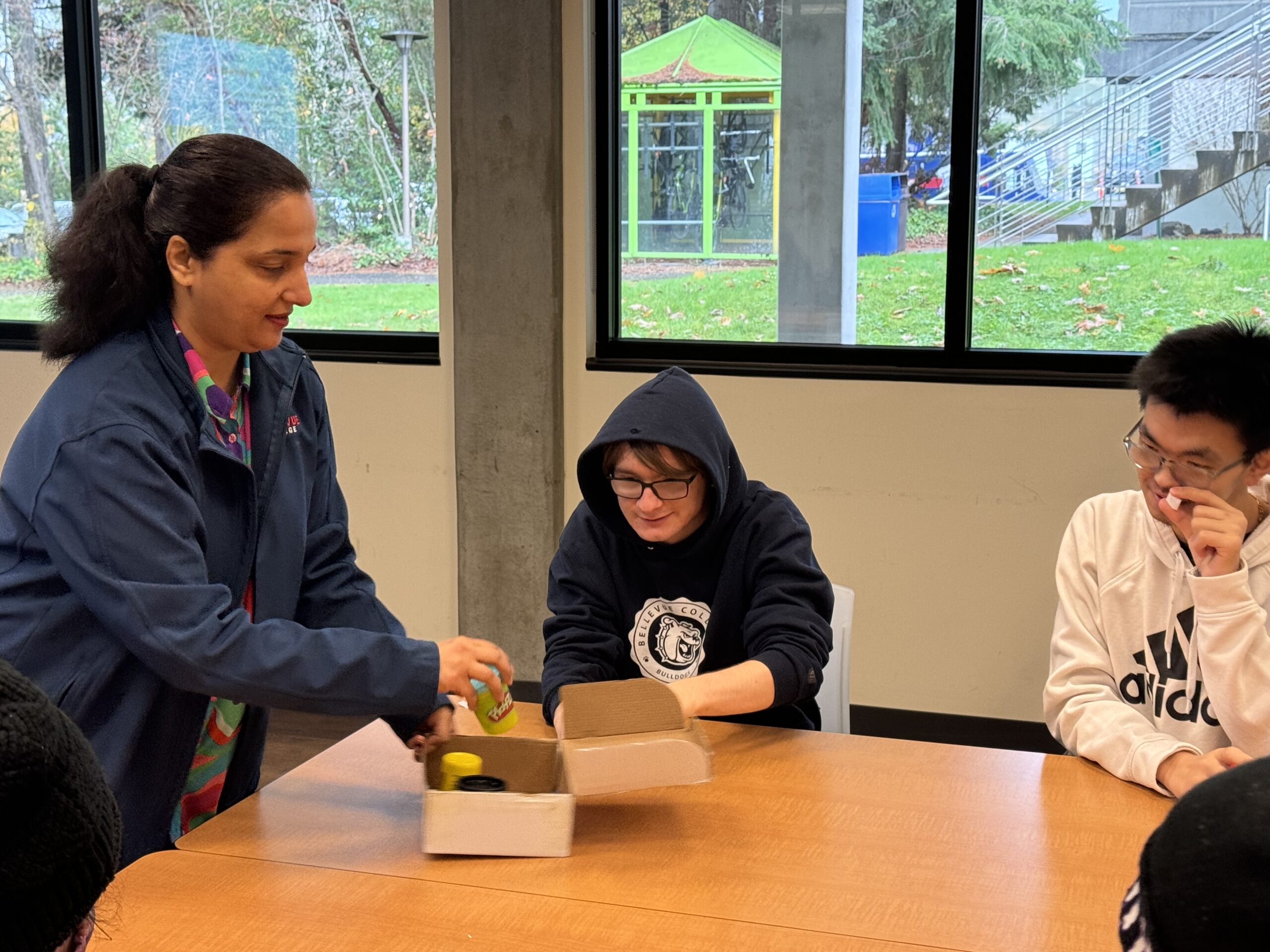 OLS students participate in a play doh experiment for intro to communications course