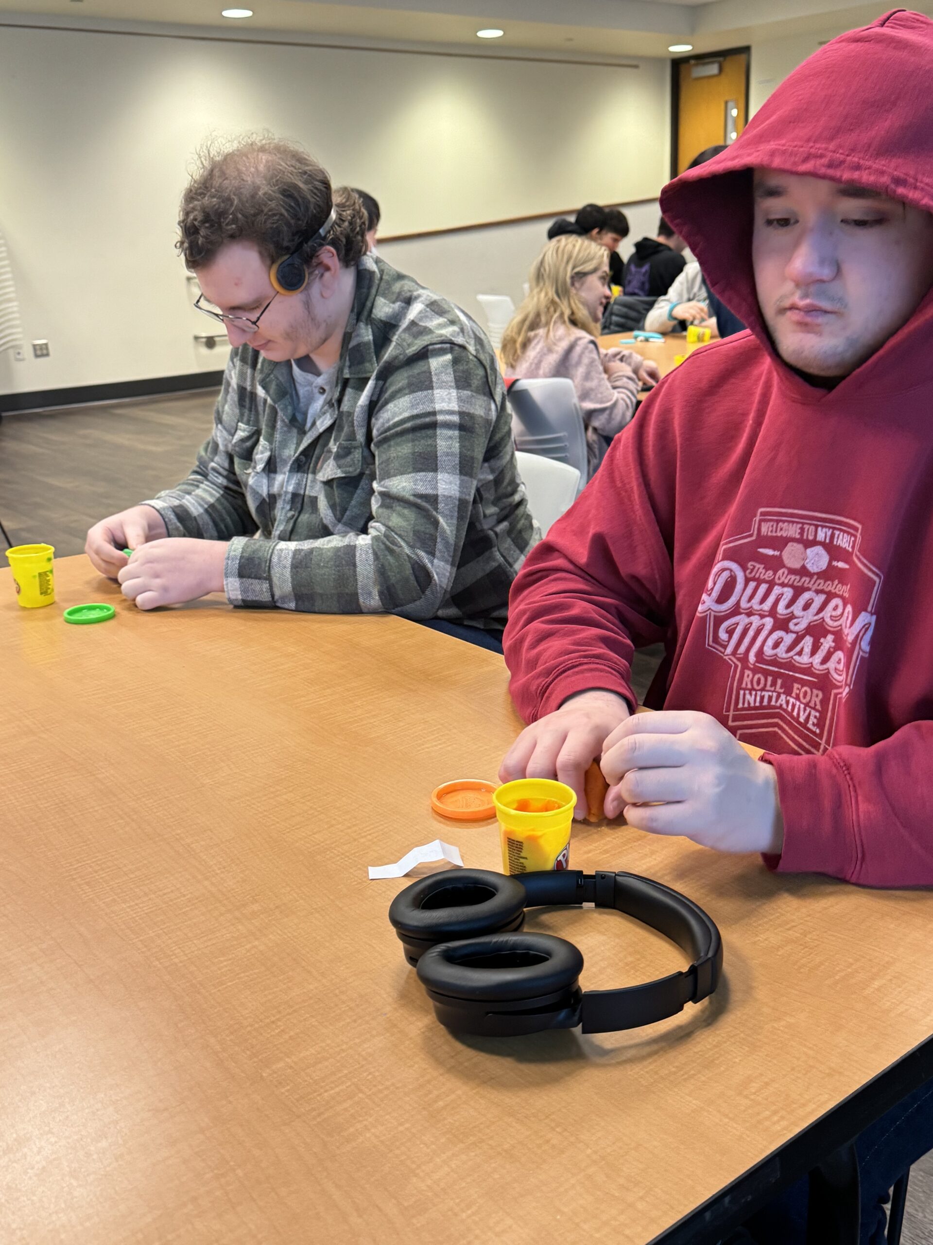 OLS students participate in a play doh experiment for intro to communications course