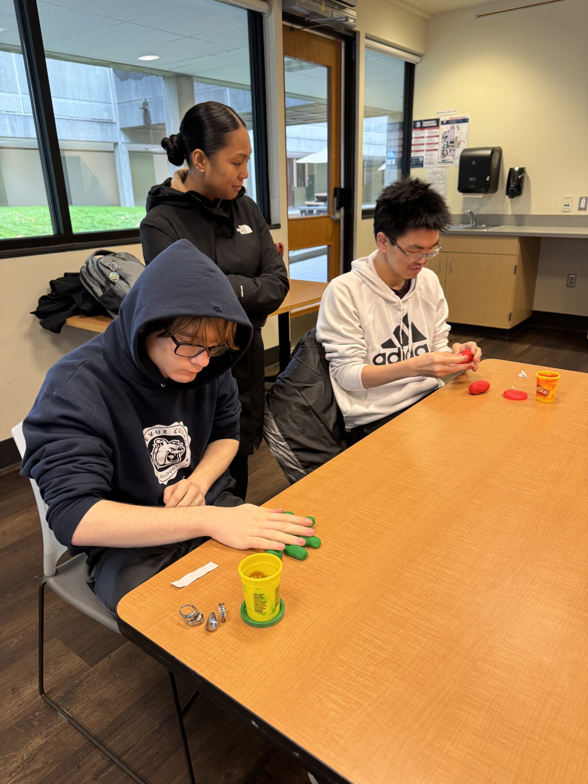 OLS students participate in a play doh experiment for intro to communications course
