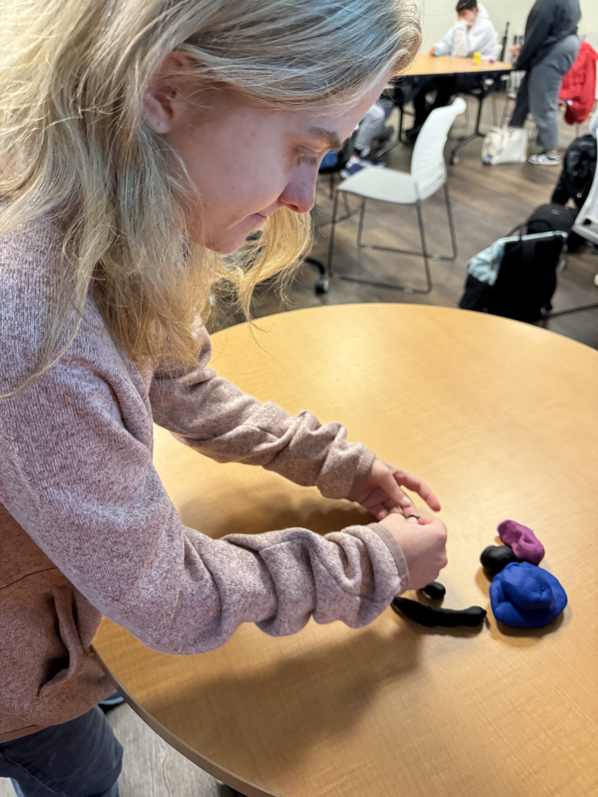 OLS students participate in a play doh experiment for intro to communications course