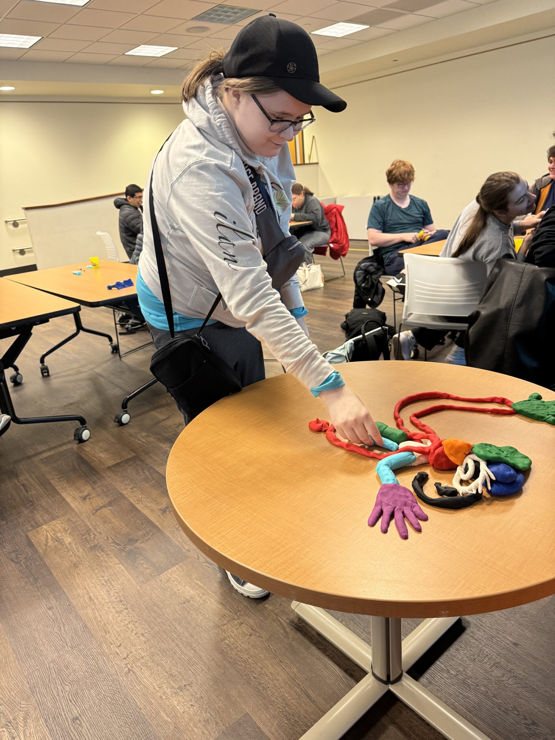 OLS students participate in a play doh experiment for intro to communications course