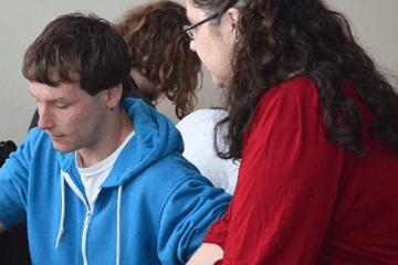 Student and faculty interact in class.