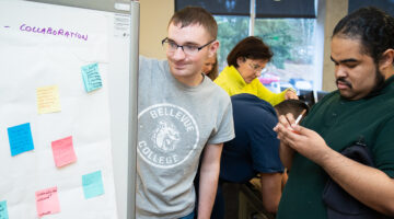 OLS students consult notes on a whiteboard at the front of class.