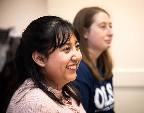 OLS students listen and smile in class.