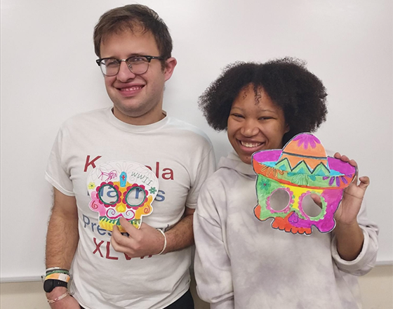OLS students present Dia de Los Muertos designs to the class.