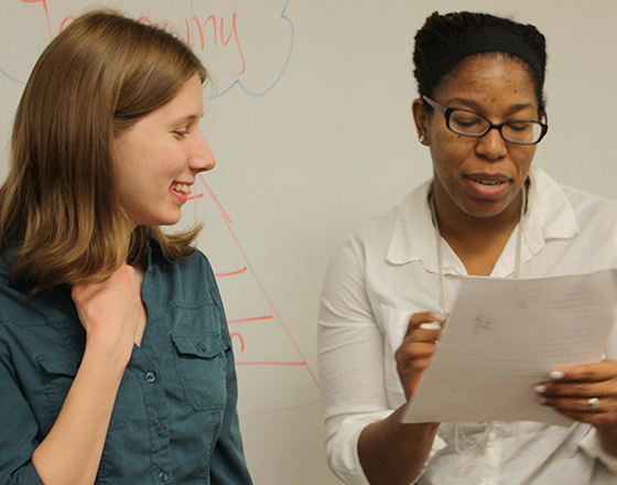 Faculty look over documents together.