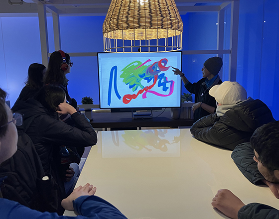 OLS students observe a guided museum presentation.