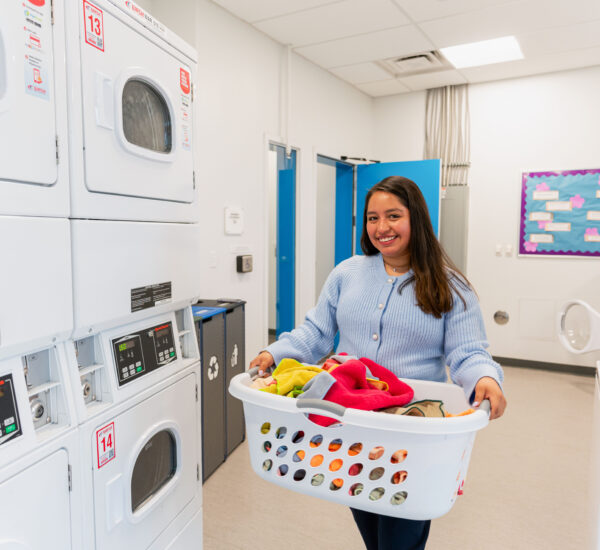 A student does laundry in the BC residence hall.