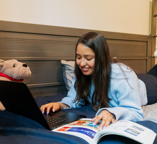 A student studies in a dorm room in student housing.