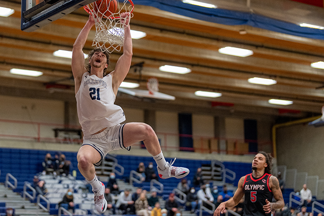 A BC Bulldog dunks over an opponent.