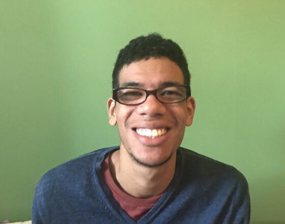 A student smiles at the camera.