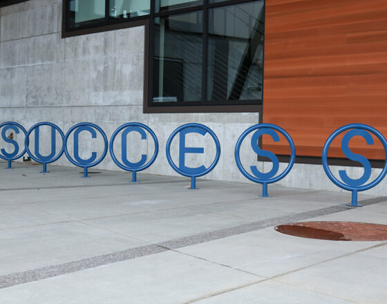 The bicycle rack in front of the U Building spells out "Success."
