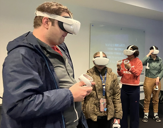 OLS students wear and experiment with VR headsets in class.