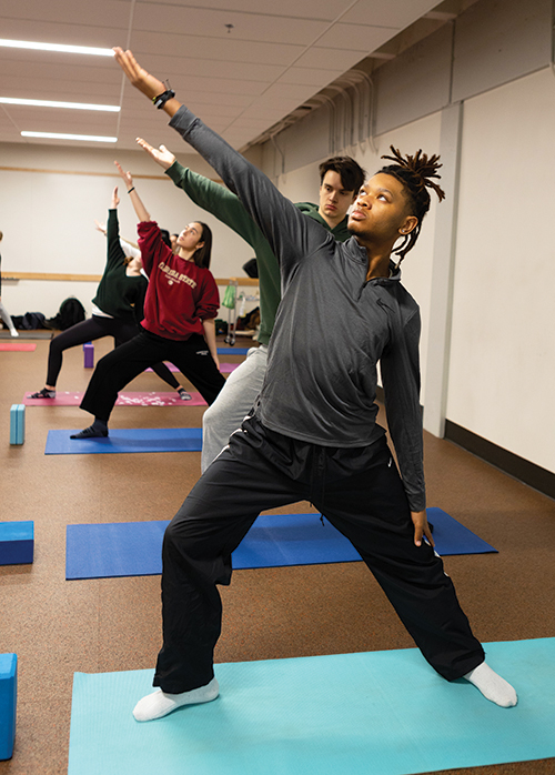 Students practice yoga.