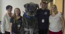 Pilar Lopez poses with OLS students and Bellevue College's mascot, Brutus.